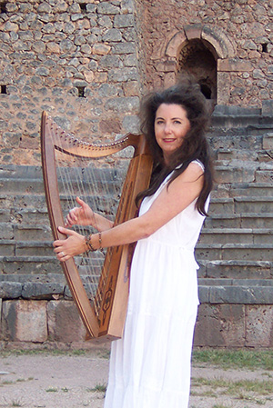 Lori Pappjohn and her harp performing ancient Greek music in Delphi.